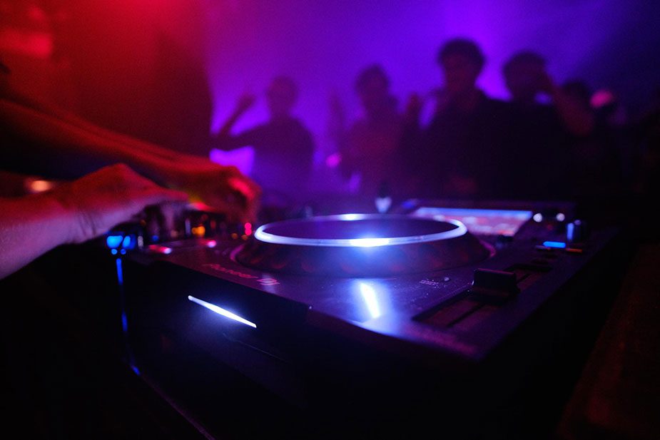 A DJ spins records at a hip Toronto nightclub