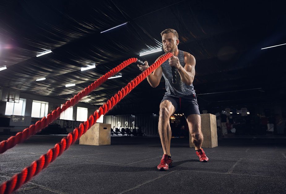 A man exercises with battle ropes at a Toronto fitness centre