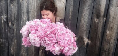 Women enjoy smelling flowers
