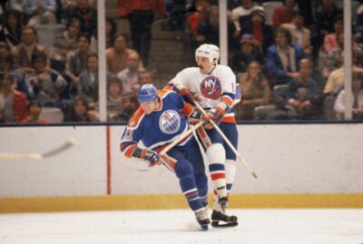 Canadian hockey player Mark Messier (left) of the Edmonton Oilers jostles for position with Bryan Trottier of the New York Islanders during a game in the 1981 - 82 season. (Photo by Bruce Bennett Studios via Getty Images Studios/Getty Images)