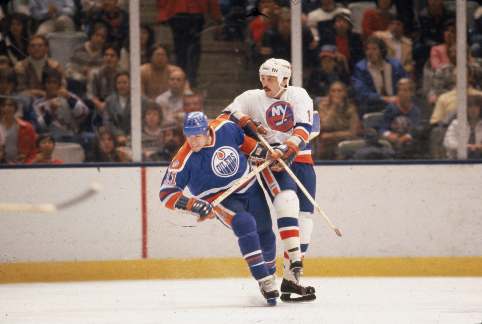Canadian hockey player Mark Messier (left) of the Edmonton Oilers jostles for position with Bryan Trottier of the New York Islanders during a game in the 1981 - 82 season. (Photo by Bruce Bennett Studios via Getty Images Studios/Getty Images)