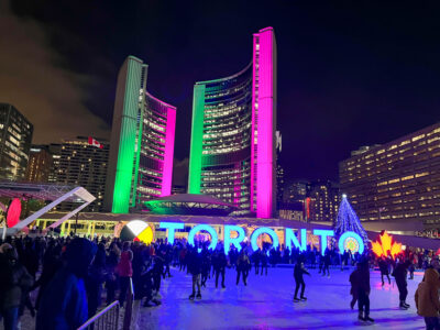 People ice skating at Nathan Philips Square.