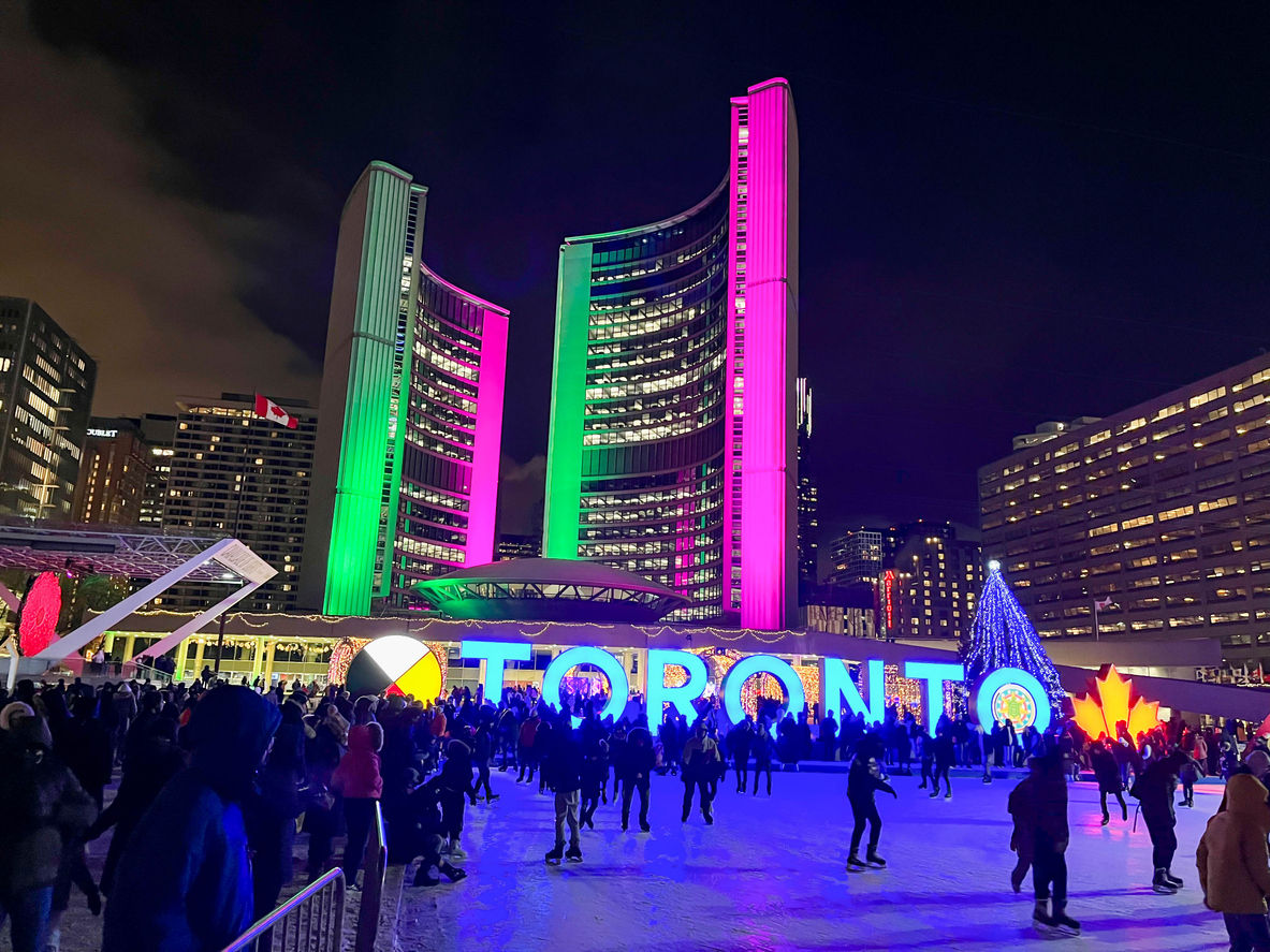 People ice skating at Nathan Philips Square.