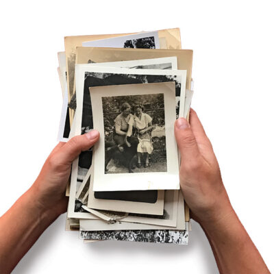 Hands Holding Stack of Old Photographs