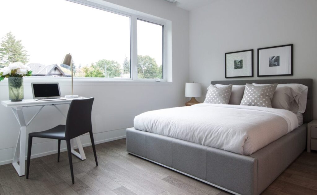 bed and a table near window